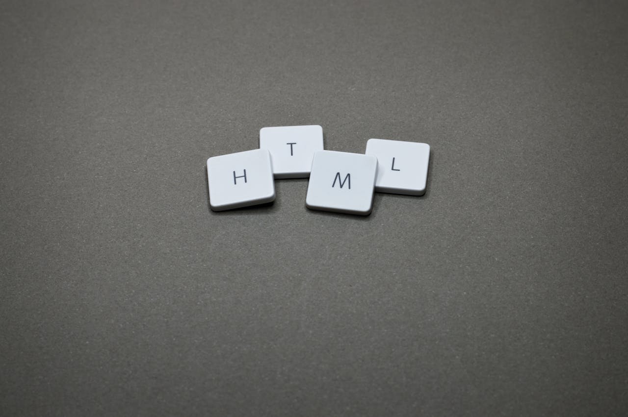 Minimalist image of HTML keycaps against a gray background, perfect for digital and web design themes.